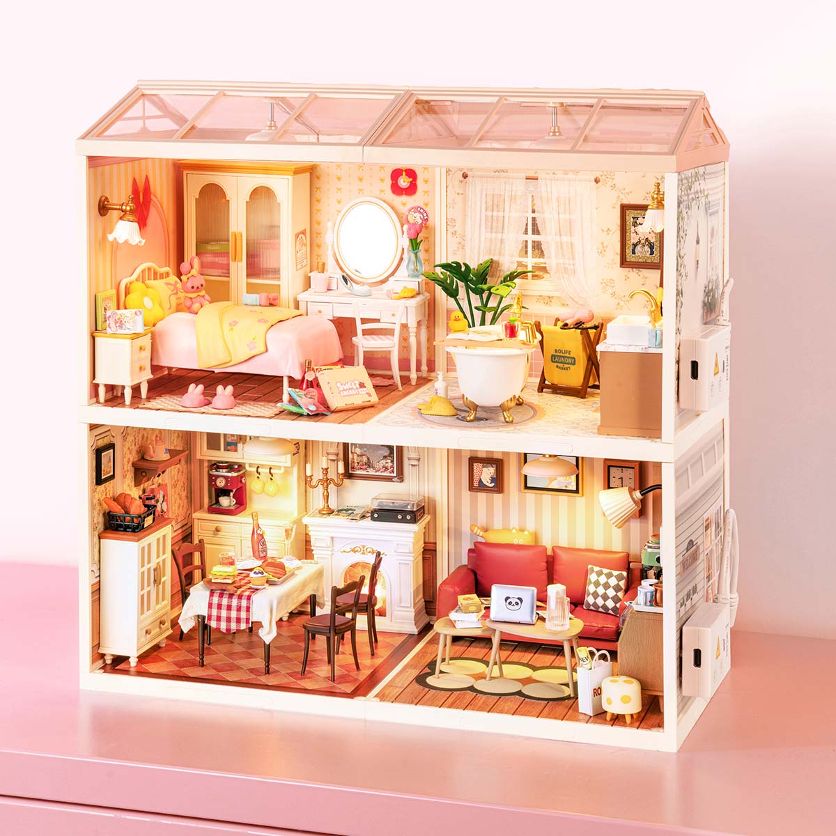 Rolife Super Creator 4-in-1 Four Grid miniature pink house showing a bakery and cake shop on the lower two sections with a flower shop and diner on the right