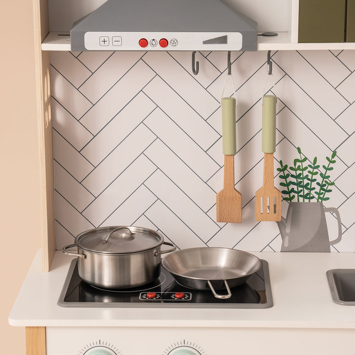 ROBUD wooden toddler play kitchen WG187 cooktop detail showing stainless pots on burners with white herringbone tile background