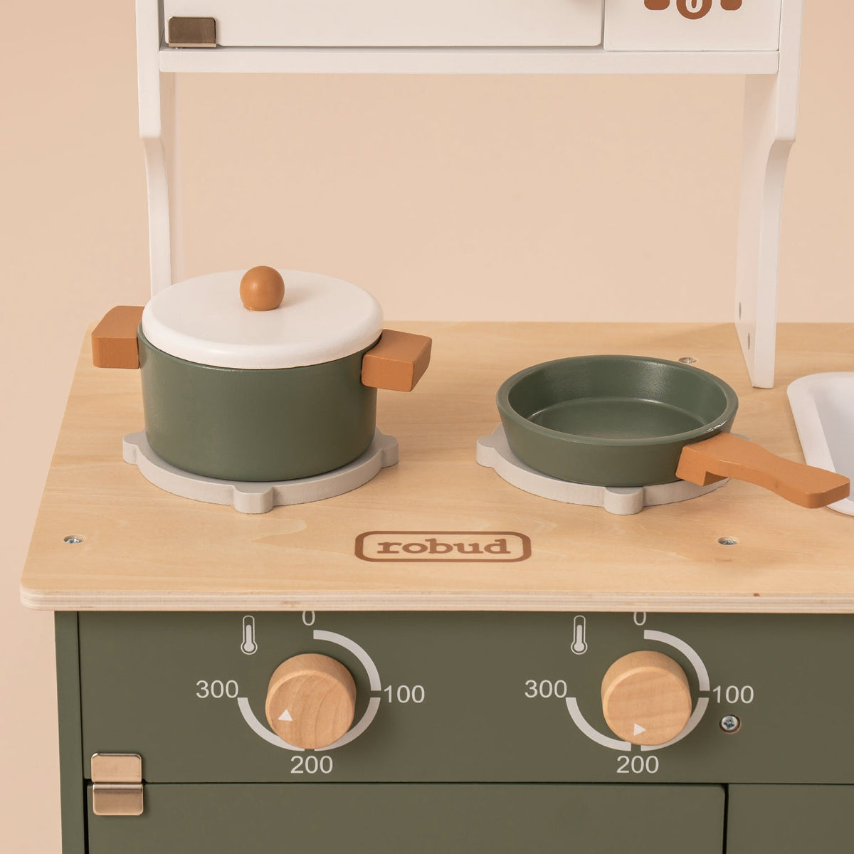 ROBUD vintage green wooden play kitchen WCF04 cooktop detail with green pot and pan on burners with gold knobs
