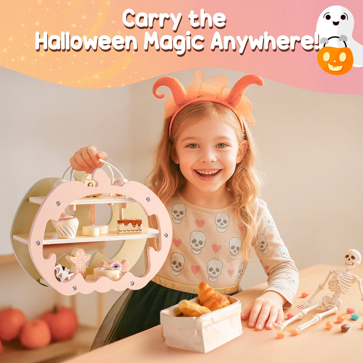 Young girl in skeleton costume playing with ROBUD Halloween Candy House at a table covered in Halloween party food and treats