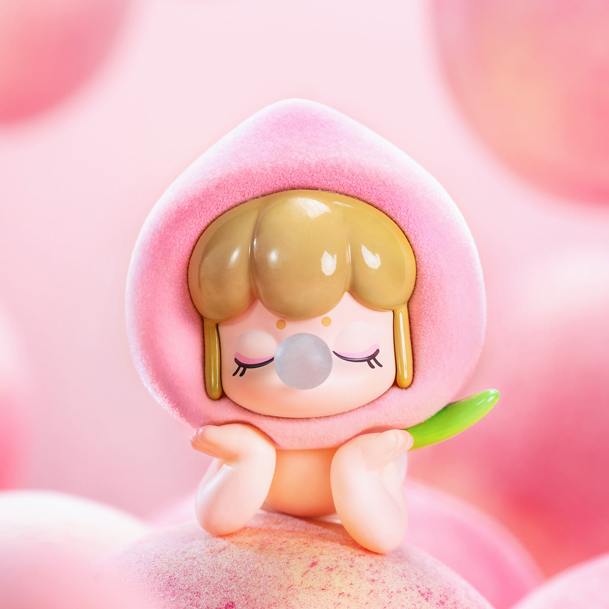 Rolife Baby Nanci Fruits hidden Peach edition figure in soft pink flocked costume sitting atop fuzzy pink peach fruits against a dreamy pastel pink background close-up view