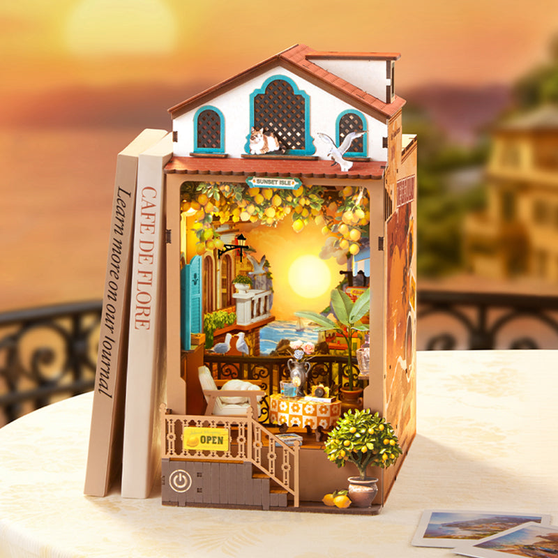 Rolife bookend dollhouse miniature kit shaped like a seaside cafe with a balcony and warm lighting, standing between books