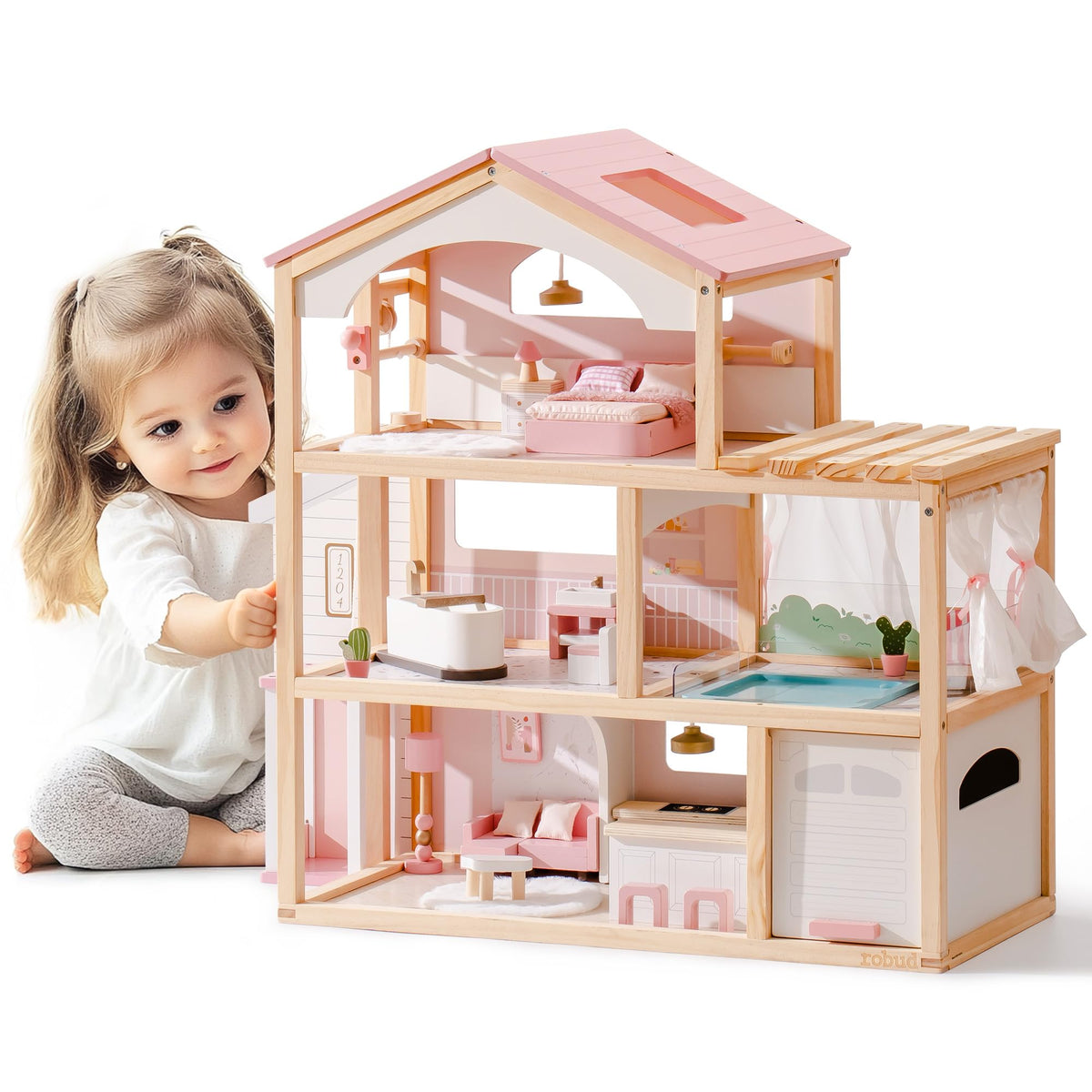 Young girl playing beside ROBUD pink and natural wood three-story open-concept dollhouse with furnished rooms