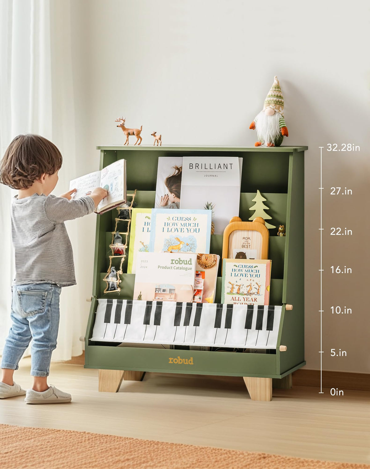 ROBUD Wooden Kids Bookshelf Piano green version with a young boy reaching for a book from the green shelves in a warm room with toy animals on top and height measurement guide on the right