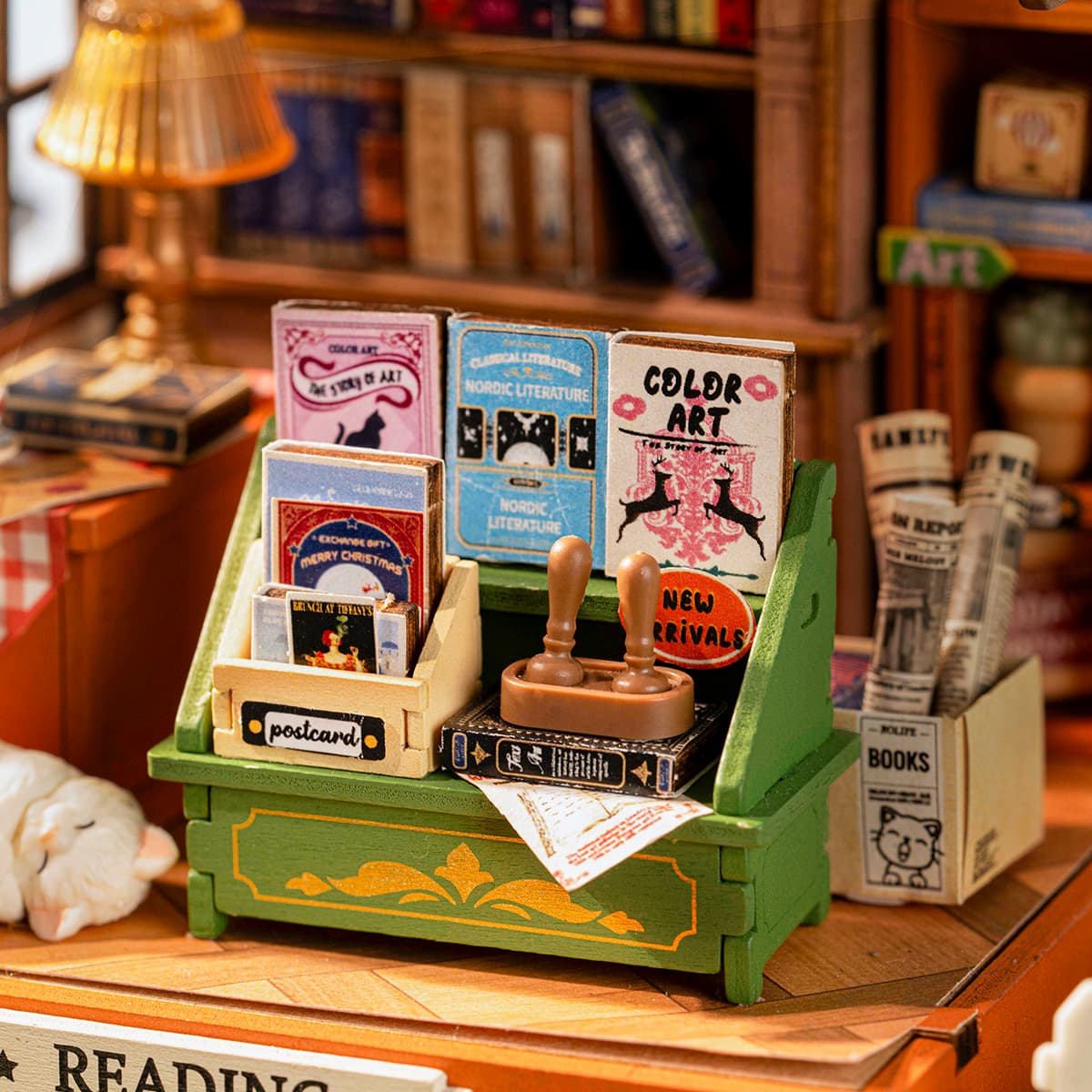 Rolife Muse Bookshop interior counter with colorful art book rack, postcard stand and miniature rubber stamp