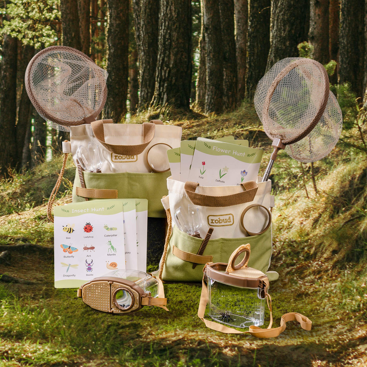 ROBUD dual kids explorer kit displayed in a forest setting with two green canvas bags, bug containers, butterfly nets, and guide cards