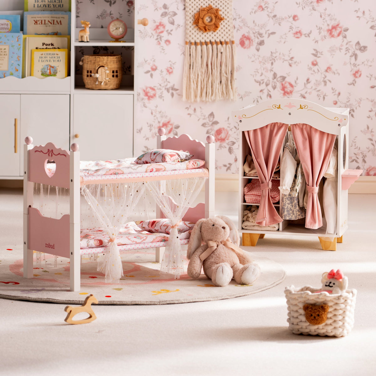 ROBUD white doll bunk bed and pink wooden wardrobe together in a bohemian room with macramé wall art and floral wallpaper.