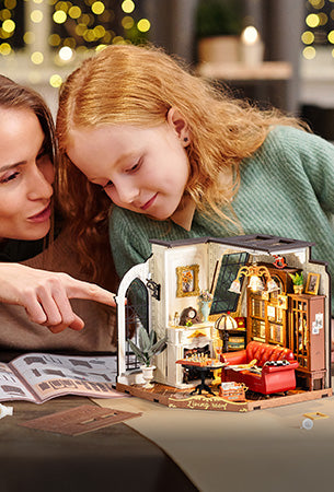 Mother and young daughter admiring a glowing Rolife DIY miniature living room house together on a table in a warm home environment
