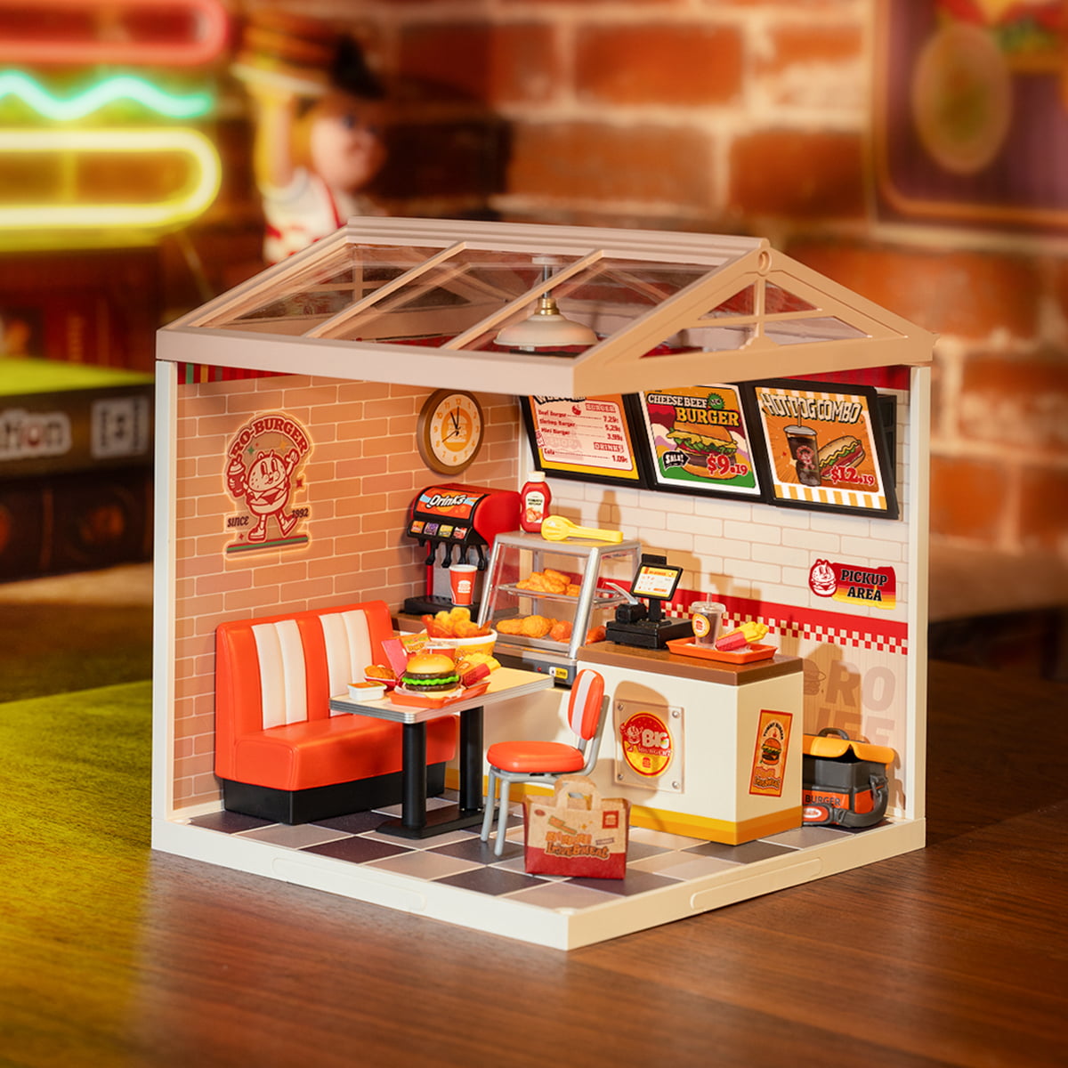 Rolife Yum Yum Burgers DW010 miniature diner with greenhouse glass roof glowing under warm light with red booths and fast food menu boards visible
