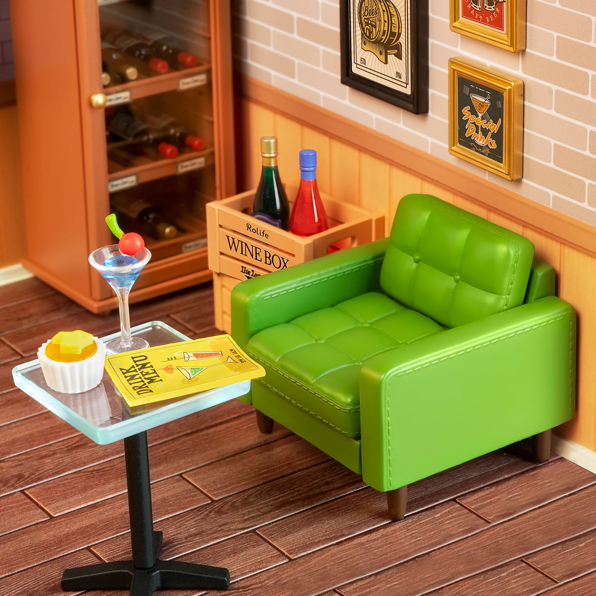 Rolife Leisurely Cheers Bar DW012 close up of the green sofa seating area with cocktail table wine bottles and bar posters on brick wall