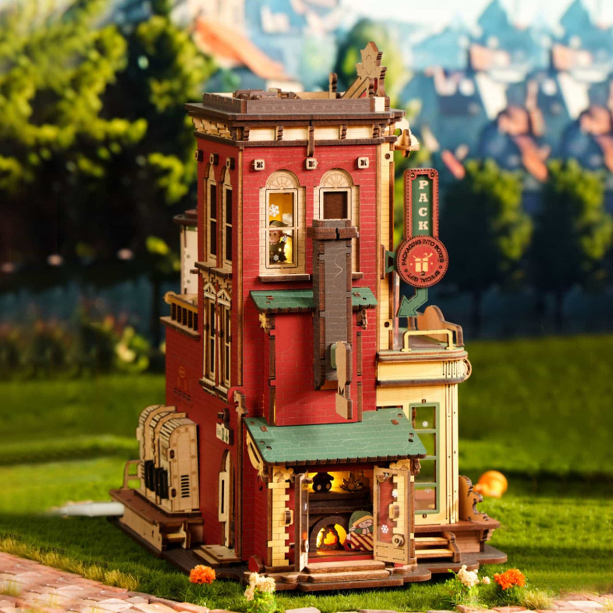 ROKR Dream Gift Factory EAB01 outdoor lifestyle scene showing the red toy factory building with glowing interior illumination against a garden background