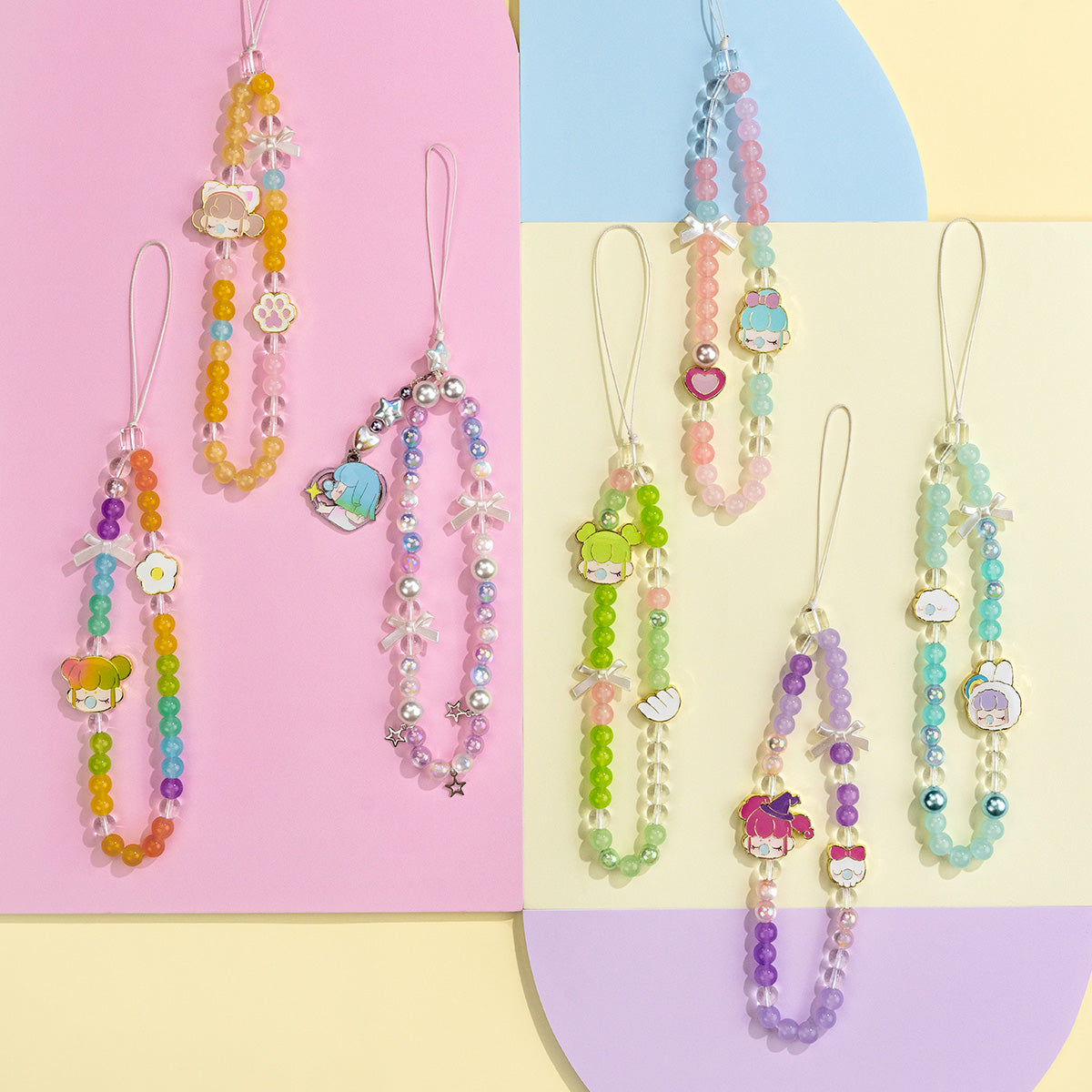 Seven Rolife Nanci Sweet Time phone lanyards in assorted pastel bead colors arranged across a pink and yellow pastel geometric backdrop.