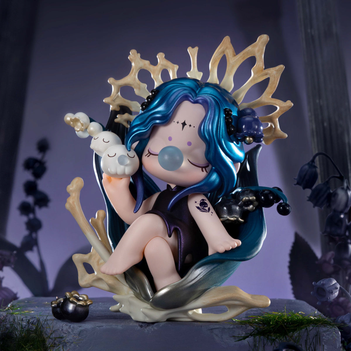 Blue-haired figurine seated on a bone-shaped throne with a golden halo against a purple mystical backdrop