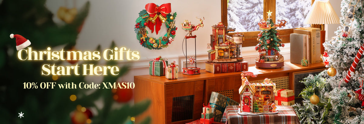 Robotime Christmas sale page banner featuring a lit craft room with gift boxes and 10% off promo code