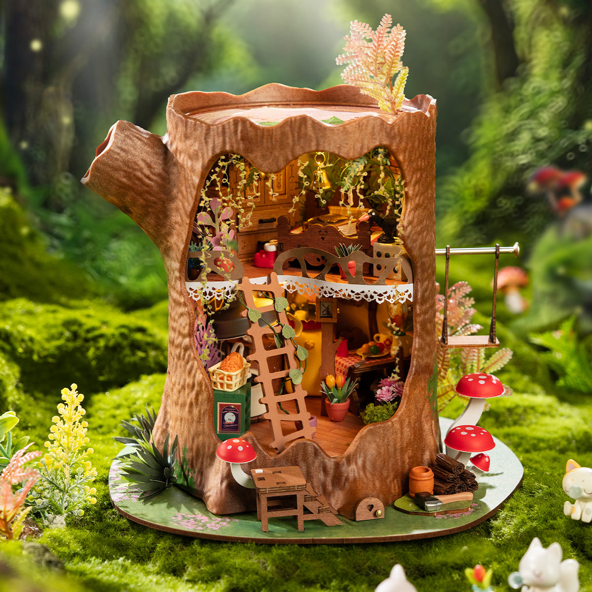 Rolife Fairytale Tree House DG179 DIY miniature assembled and glowing with warm LED light on a wooden shelf showing the tree-trunk exterior with swing and fern plants