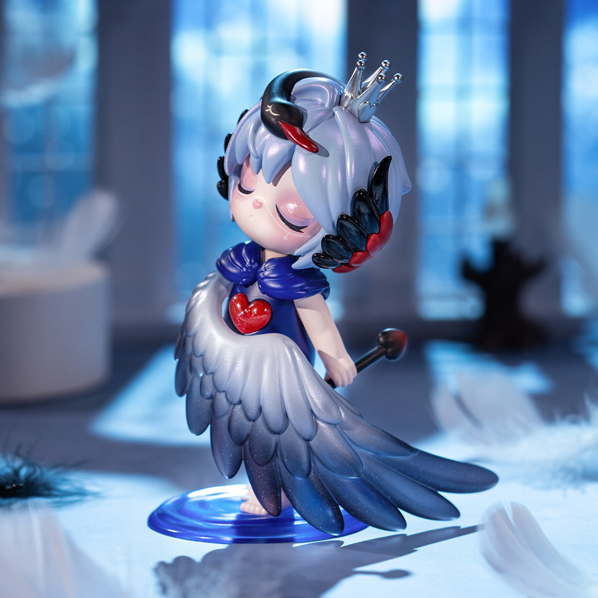 Rolife Suri Mystery Castle SLXX Falling Swan figure close-up showing silver crown, blue swan wing cloak, and red heart gem on a blurred castle backdrop