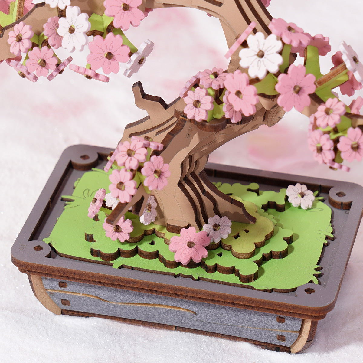 Rolife Sakura Bonsai TG415 close-up of pink flower clusters and wooden branch fork detail on green base