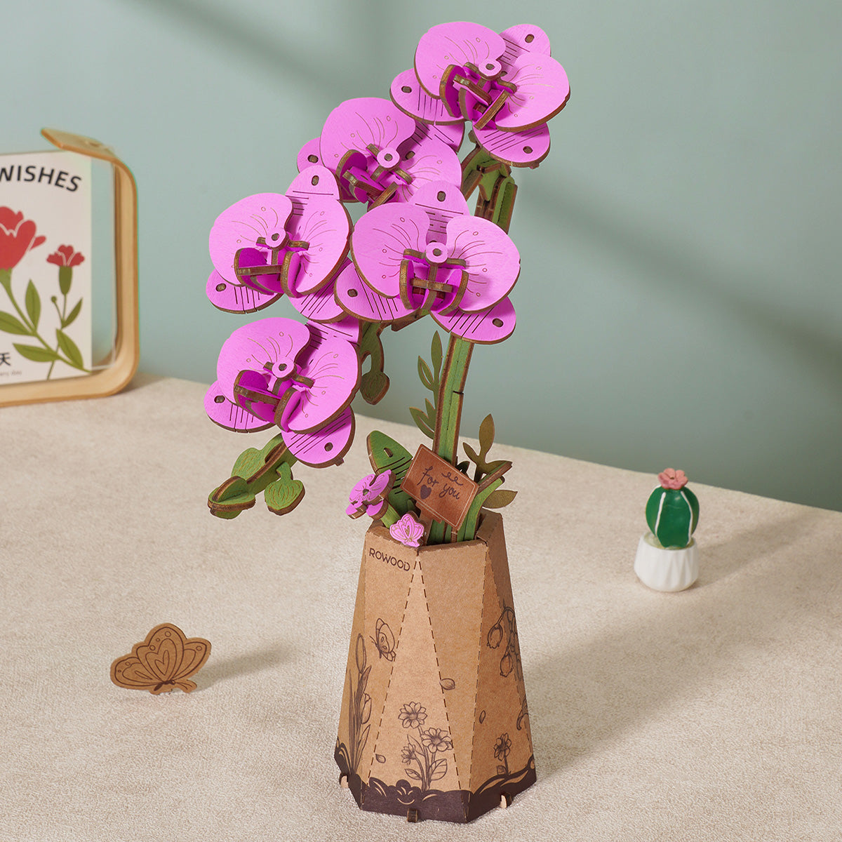 Rowood pink tulip wooden flower bouquet kit TW082 assembled with two blooms and green leaves standing in a kraft paper pot on a sage green table