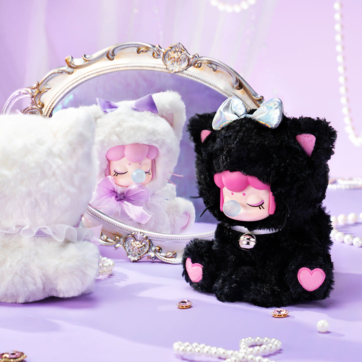 Rolife Nanci Tea Time Kitties lifestyle showing Midnight Honey and White Angel plush pendants beside ornate mirror with pearls