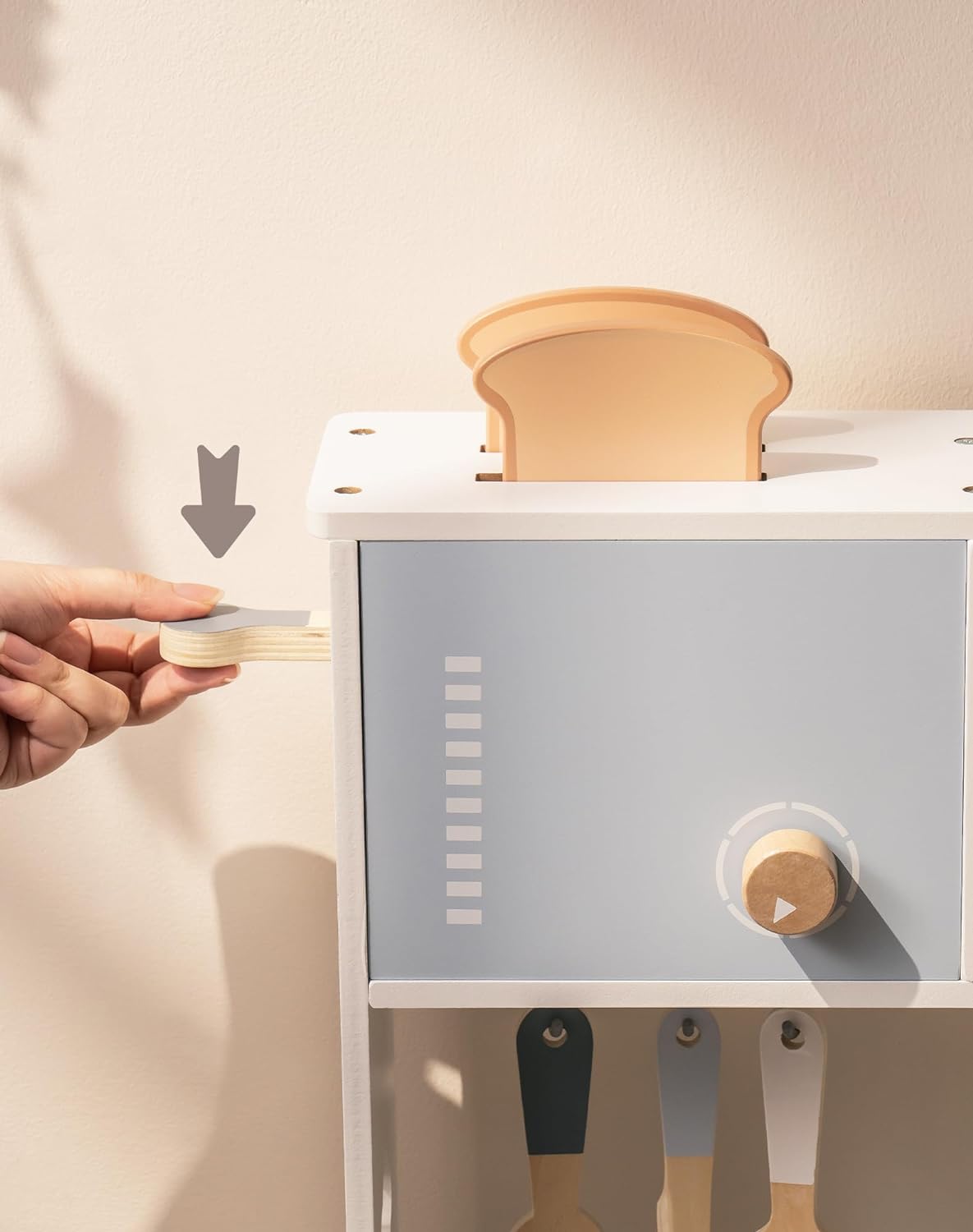 Robud kitchen toy close-up of toaster slot with bread piece being inserted into grey appliance panel