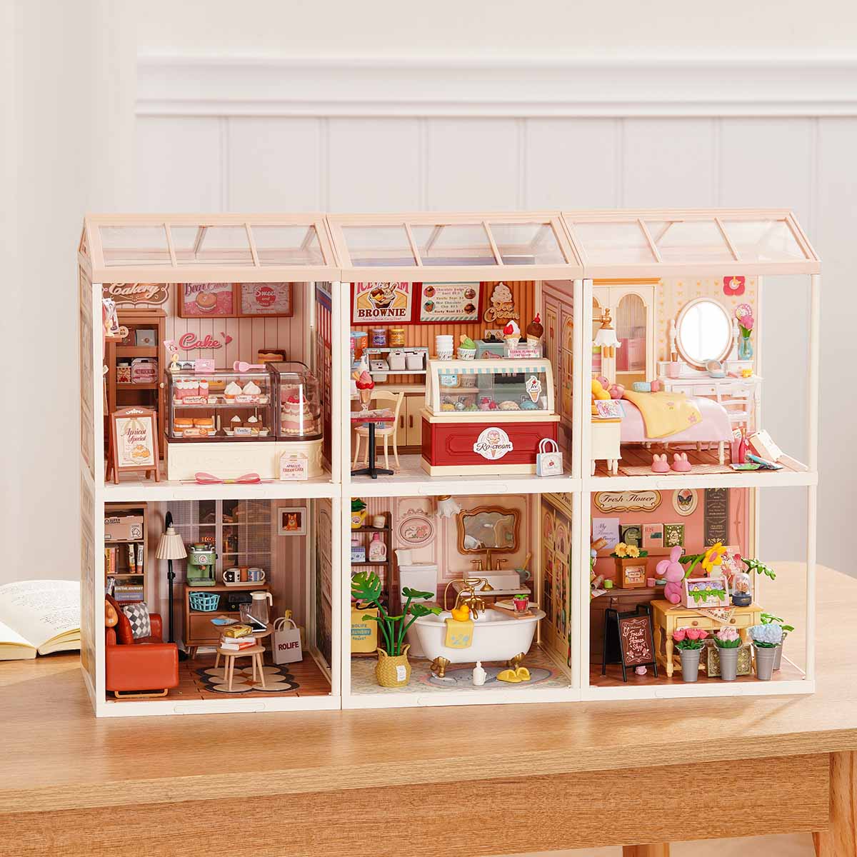 Rolife Super Creator Series 6-in-1 Six Grid miniature showing six street-style shop rooms including Super Bubble Tea, bakery, Burger Shop, bar, bookstore, and afternoon tea on a wooden table.