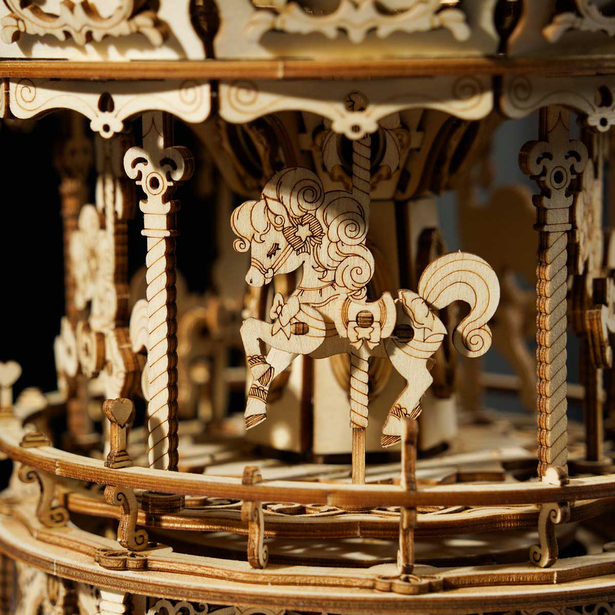 ROKR Romantic Carousel music box close up showing carved white horse riders and ornate filigree columns