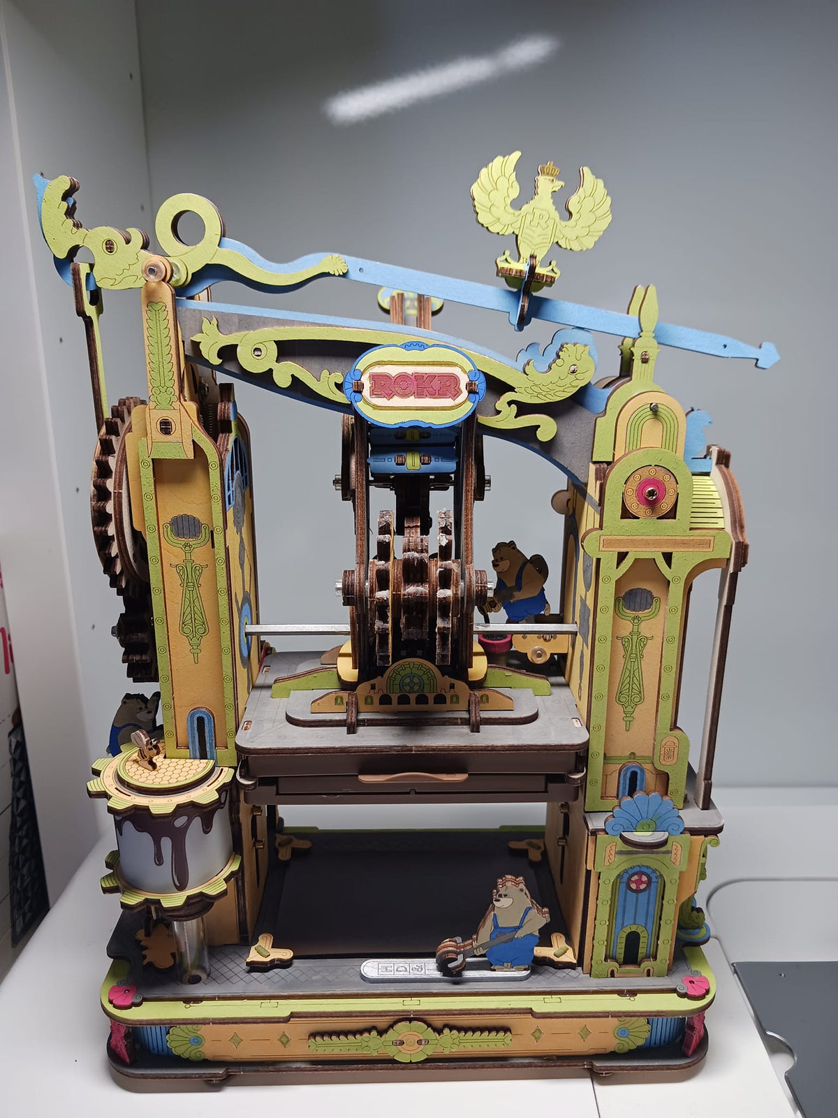 Robotime ornate wooden stage model has pastel columns, bats, and a central booth.