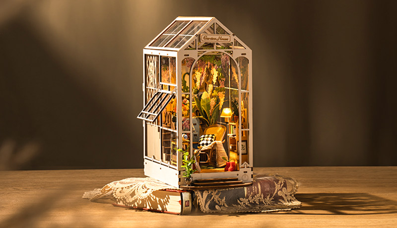 Robotime tall lighted greenhouse model with glass panels, plants and warm interior glow