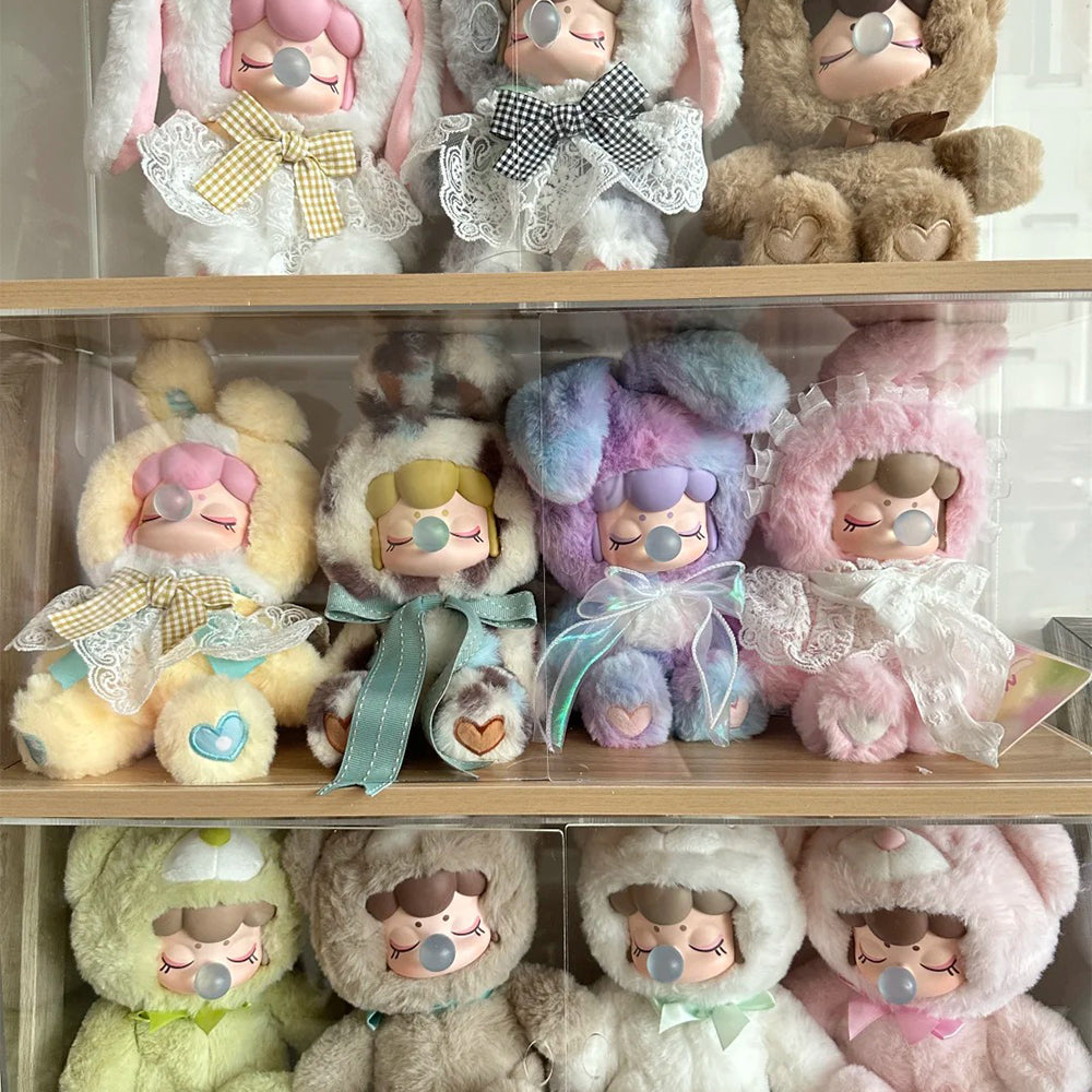 Rolife Nanci plush dolls in bunny and bear costumes displayed on a shelf, featuring soft pastel pink, blue and cream tones.