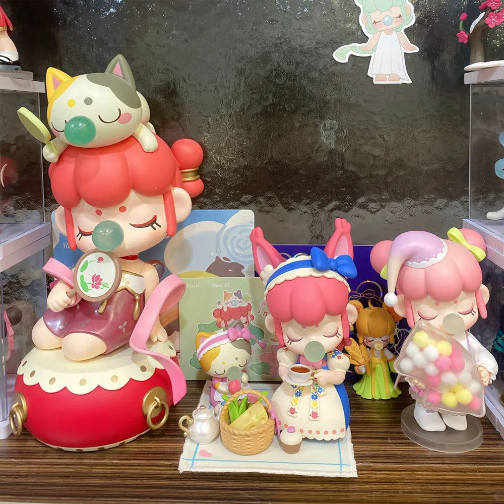 Rolife surprise figure dolls with cat ears posed around a layered cake scene