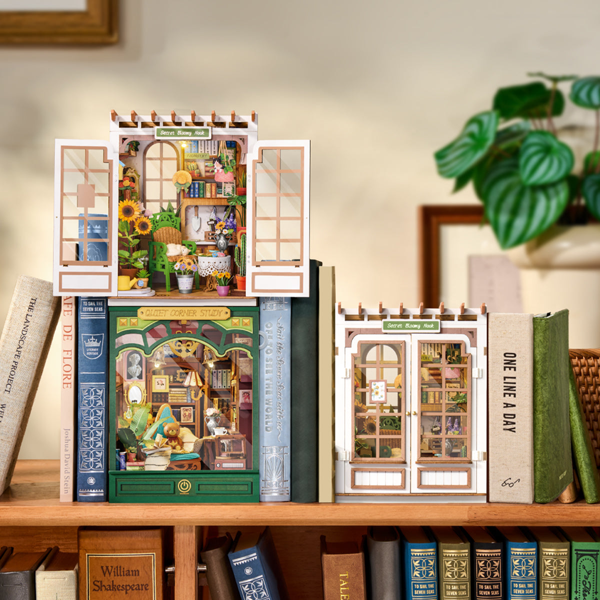 Two Rolife book nooks on a bookshelf, a sunflower garden nook beside a library-style nook, nestled between real books